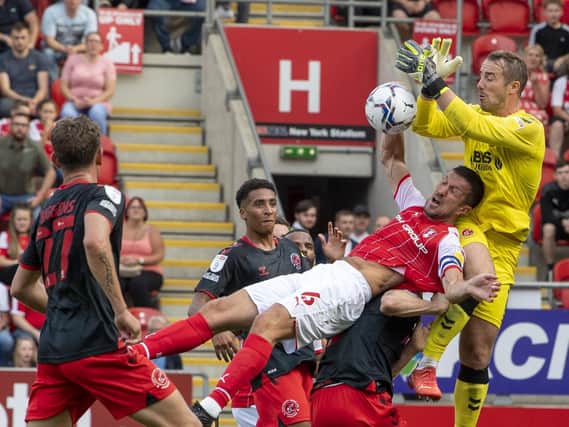 Rotherham United skipper Richard Wood challenges Fleetwood Town goalkeeper Alex Cairns. Pictures: Tony Johnson