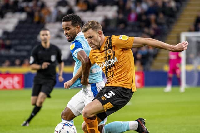 Hull City's Callum Elder grapples with Rams Nathan Byrne. (Picture: Tony Johnson)