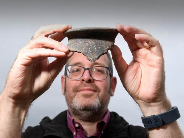 North Yorkshire County Council principal archaeologist Peter Rowe with a fragment of Roman pottery from the dig near Bedale