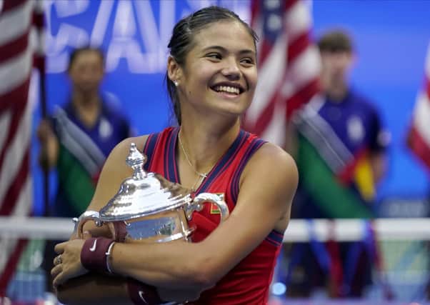 Emma Raducanu, of Britain, holds the US Open championship trophy after defeating Leylah Fernandez, of Canada, during the women's singles final of the US Open tennis championships. (AP Photo/Seth Wenig)