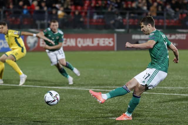Northern Ireland's Paddy McNair scores his side's fourth goal during the World Cup 2022 Group C qualifying soccer match between Lithuania and Northern Ireland (AP Photo/Mindaugas Kulbis).