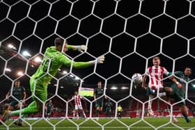 Barnsley goalkeeper Bradley Collins saves a shot from Stoke City's Sam Surridge.