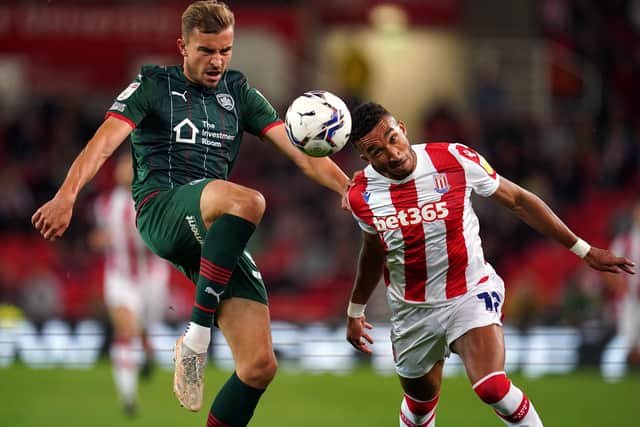 Barnsley's Michal Helik (left) and Stoke City's Jacob Brown challenge for the ball. Picture: PA.