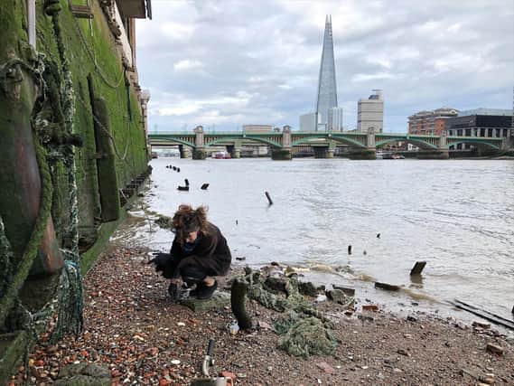 Ruth Claydon looks for treasures on the shores of the River Thames in London,