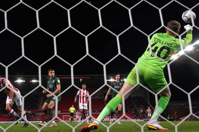 Barnsley goalkeeper Bradley Collins (right) saves a shot from Stoke City's Mario Vrancic (left) (Picture: PA)