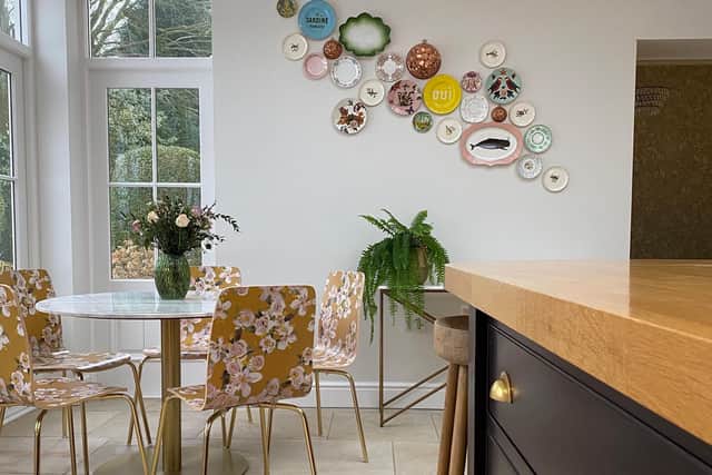 Chairs from Anthropologie and a dispaly of  plates add colour and interest