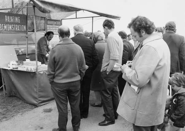 .A weights and measures inspector makes notes at Pocklington's market in 1973.