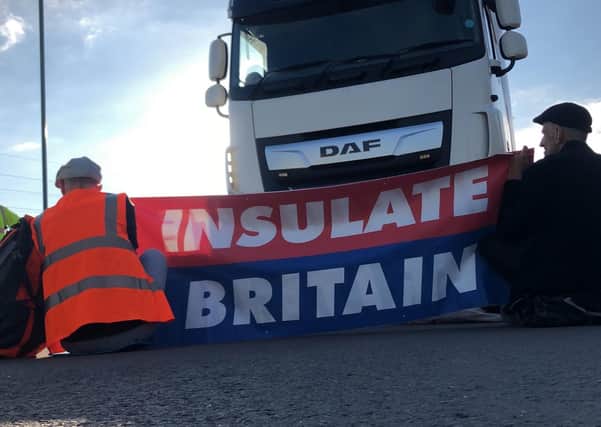 Handout photo issued by Insulate Britain of protesters taking part in blocking the M25 motorway in London.