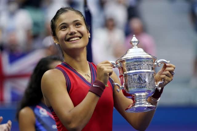 Emma Raducanu, of Britain, holds up the US Open championship trophy after defeating Leylah Fernandez, of Canada. (AP Photo/Seth Wenig)