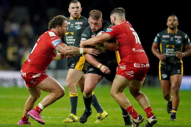 Leeds Rhinos' Tom Holroyd is tackled by Hull Kingston Rovers' Korbin Sims and Matthew Storton (Picture: PA)
