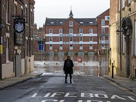 A woman watches flood water rise in York. The problem of flooding is expected to become worse in coming years.