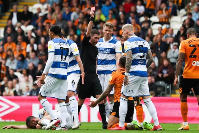 Hull City's George Moncur (centre) is given a red card against QPR> Picture: PA.