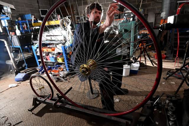 Penny Farthing maker Christian Richards, pictured at work in his workshop. Image by Simon Hulme