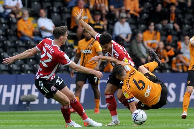 Hull's Richard Smallwood is challenged by Morgan Gibbs-White and Ben Davies of Sheffield United (Picture: Simon Hulme)