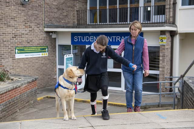 Molly Birch and her support dog Chess negotiate steps at Wensleydale School.