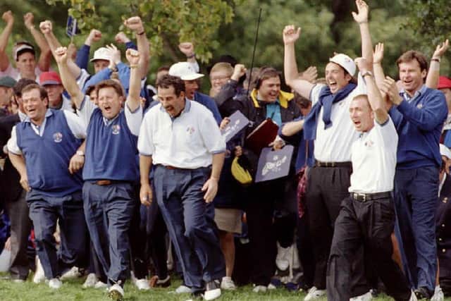 Members of the European Ryder Cup team run onto the 18th green after Philip Walton of Ireland sank his putt to win his match and the  Ryder Cup 24 September at the Oak Hill Country Club in Rochester, NY.  (Picture: ROBERT SULLIVAN/AFP via Getty Images)
