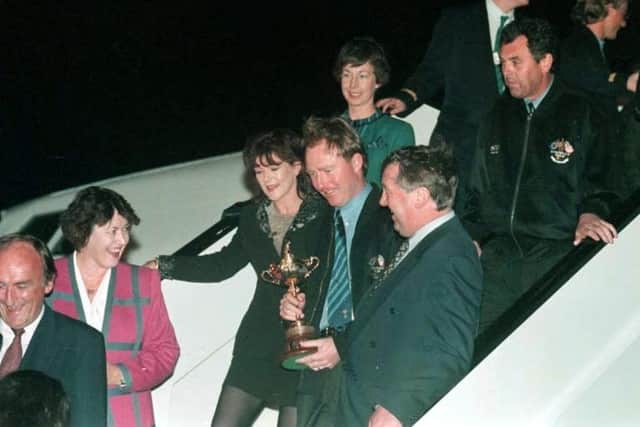 Europe's victorious Ryder Cup team arrive in Dublin after the golfers beat the Americans at the weekend. Pictured with the Cup is Philip Walton (cen) with wife Suzanne while behind the couple on the stairs is team captain Bernard Gallacher (r). (Picture: Martin McCullough/PA)
