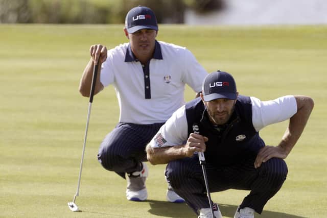 US golfer Dustin Johnson (R) and US golfer Brooks Koepka line up a putt during their his foursomes match on the second day of the 42nd Ryder Cup at Le Golf National Course at Saint-Quentin-en-Yvelines, south-west of Paris. Reports later emerged that they nearly came to blows. (Picture: GEOFFROY VAN DER HASSELT/AFP via Getty Images)