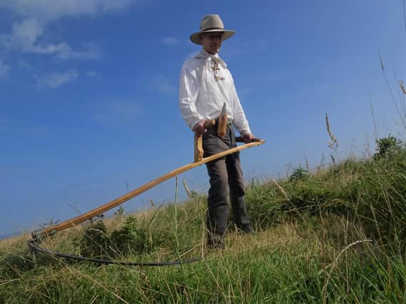 Martin Stevens with his scythe at RSPB Bempton Cliffs