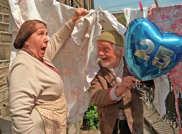 Nora Batty (Kathy Staff) gets a shock as Compo (Bill Owen) leaps from behind her washing to surprise her, as the cast of Last of the Summer Wine assembled in Homfirth on for filming of the 25th anniversary series. Picture: Mark Bickerdike.
