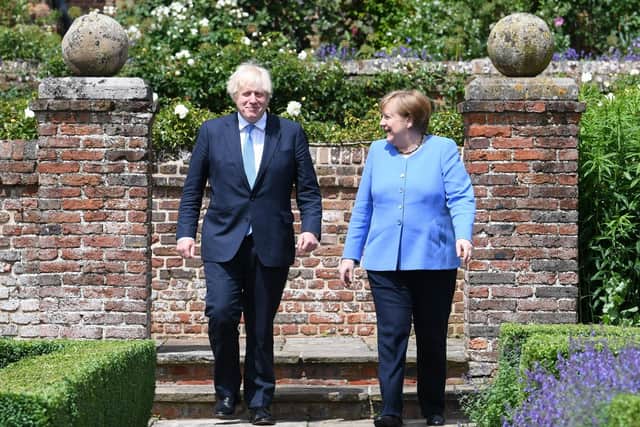 Prime Minister Boris Johnson and the Chancellor of Germany, Angela Merkel, walk through the garden at Chequers earlier this summer.