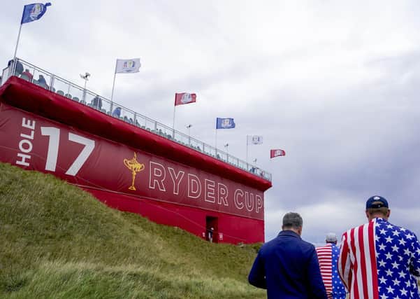 Fans walk on the 17th hole during a practice day at the Ryder Cup at the Whistling Straits Golf Course in Sheboygan, Wis. (AP Photo/Jeff Roberson)