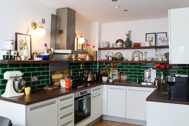 Kitchen wall cupboards were removed and green metro tiles added to transform this space