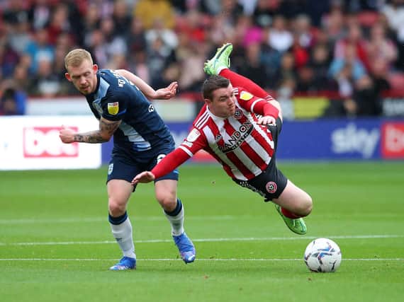 COMPETITOR: Huddersfield Town's Lewis O'Brien tackles Sheffield United's John Fleck