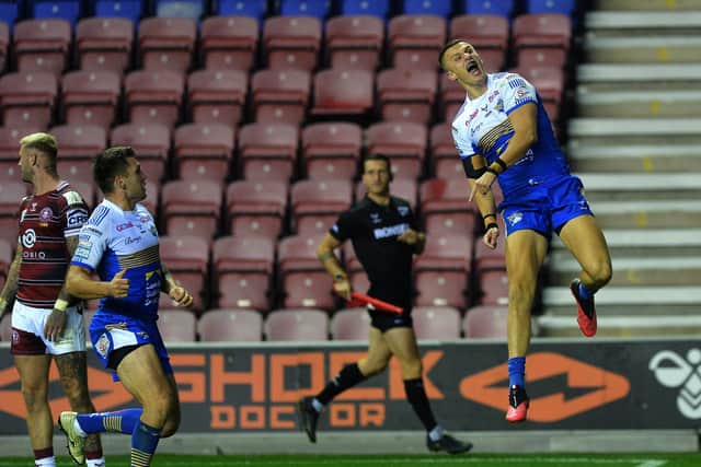PLAY-OFF WIN: For Leeds Rhinos as Ash Handley celebrates scoring the opening try at Wigan.
 Picture: Jonathan Gawthorpe