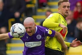Harrogate Town midfielder Alex Pattison is beaten to the ball by Stevenage's Jake Taylor. Picture: Matt Kirkham