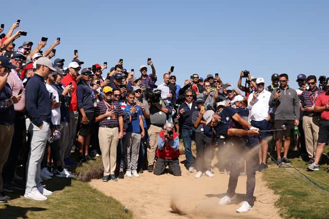 Dustin Johnson of team United States plays his shot from the bunker on the fourth hole. (Photo by Patrick Smith/Getty Images)