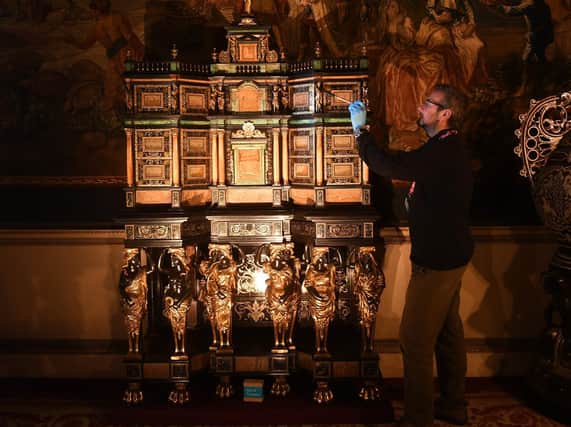 Curator Simon McCormack pictured with a 17th Century Cabinet which be by the hand of Pierre Gole a furntiure maker to Louis XIV