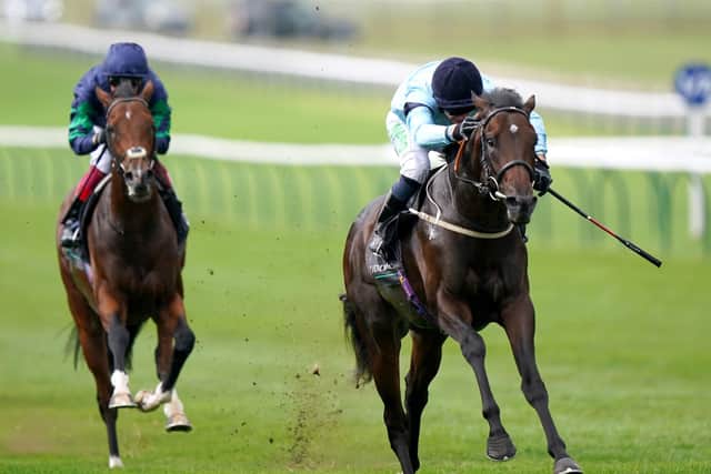 Royal Patronage (right) ridden by Jason Hart on their way to winning the Juddmonte Royal Lodge Stakes during Juddmonte Day of the Cambridgeshire Meeting at Newmarket Racecourse.