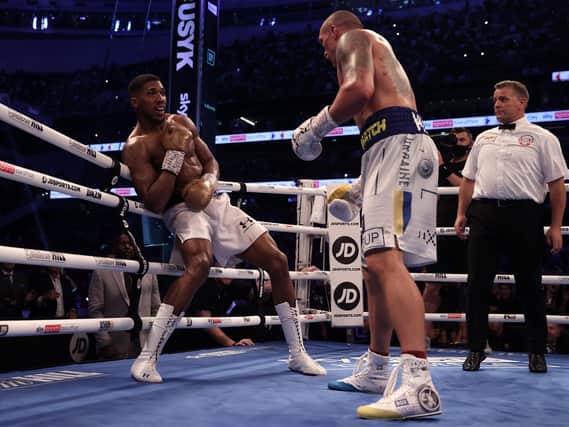 ROCKED: Oleksandr Usyk puts Anthony Joshua near the end of the heavyweight bout. Picture: Getty Images.