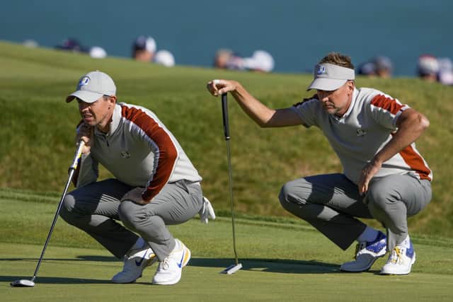 MAKE IT COUNT: Europe's Ian Poulter and Rory McIlroy line up a putt on the sixth hole during a four-ball match on day two at Whistling Straits - the holders trail 11-5 going into the third and final day. Picture: AP/Jeff Roberson