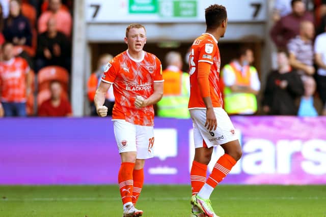Blackpool's Shayne Lavery (left) celebrates scoring his side's winning goal at Bloomfield Road: Tim Markland/PA