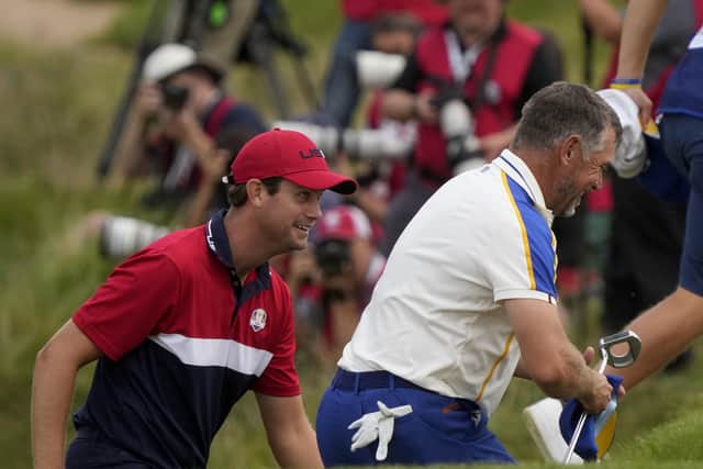 Team USA's Harris English and Team Europe's Lee Westwood walk on the 18th hole after the Ryder Cup matches at the Whistling Straits. (AP Photo/Charlie Neibergall)