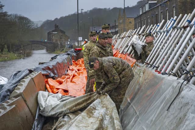 Soldiers from the Highlanders based at Catterick Garrison help build flood defences in Mytholmroyd in February 2020.