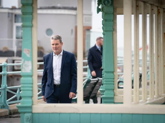 Labour leader Sir Keir Starmer walks along Brighton seafront promenade during the Labour Party conference in Brighton (PA)