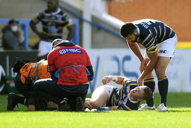 Rhinos' Harry Newman is consoled by Rhyse Martin after his injury last year. Picture: Jonathan Gawthorpe