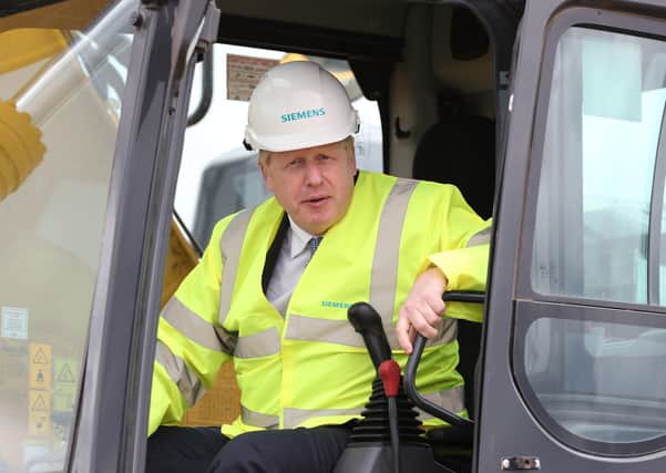 Prime Minister Boris Johnson in the cab of a digger during a visit to the Siemens Rail factory construction site in Goole as he is urged to rebrand the Tories as the Workers' Party.