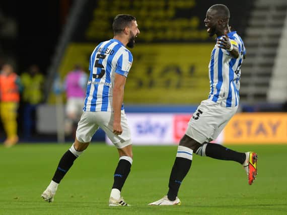 Alex Vallejo celebrates his opener for Huddersfield Town with team-mate Naby Sarr in an eventful game against Blackburn at the John Smith's Stadium. Picture: Bruce Rollinson.