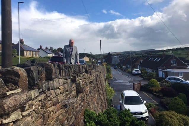 Councillor Donald Firth by the wall