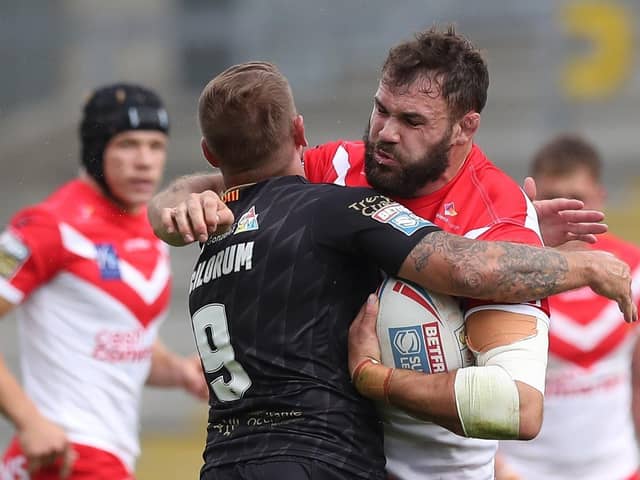 St Helens' Alex Walmsley is tackled by Catalan Dragons' Michael Mcilorum.