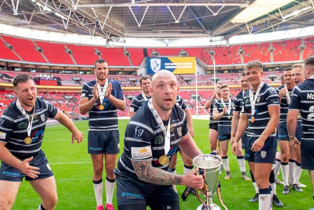 BIG DAY OUT: Featherstone Rovers' John Davies prepares to lift the AB Sundecks 1895 trophy in front of the fans. Picture by Allan McKenzie/SWpix.com