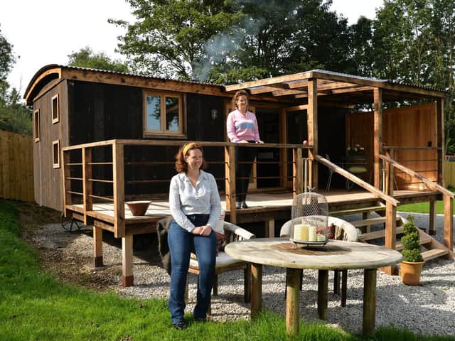 The Brader sisters - now Charlotte Russell and Emma Lund - outside a shepherd's hut on their parents' Wolds farm