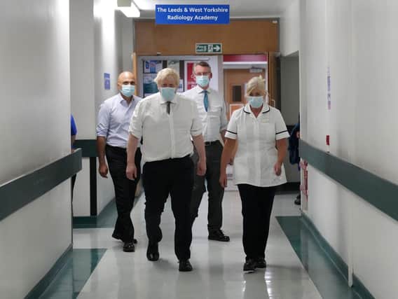 Prime Minister Boris Johnson and Health Secretary Sajid Javid (left) speak with staff as they view an MRI scanner during a visit to Leeds General Infirmary in West Yorkshire (PA)