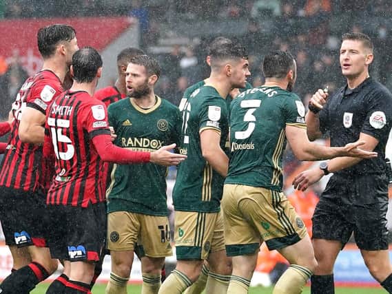 Sheffield United players protest to referee Rob Jones following his decision to award Bournemouth a controversial 62nd-minute penalty. Pictures: PA
