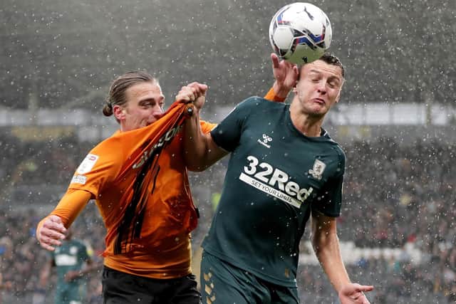 Scruff of the neck: Hull City’s Tom Eaves, left, and Middlesbrough’s Dael Fry tussle in the heavy rain at the MKM Stadium in a game that was settled in stoppage time (Pictures: Richard Sellers/PA)