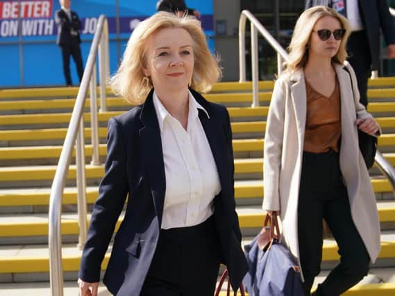 Foreign Secretary Liz Truss (centre) walks to a fringe event during the Conservative Party Conference in Manchester. (PA/Jacob King)
